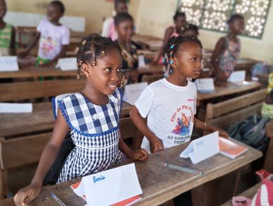 Young students actively participating in a lively classroom setting.